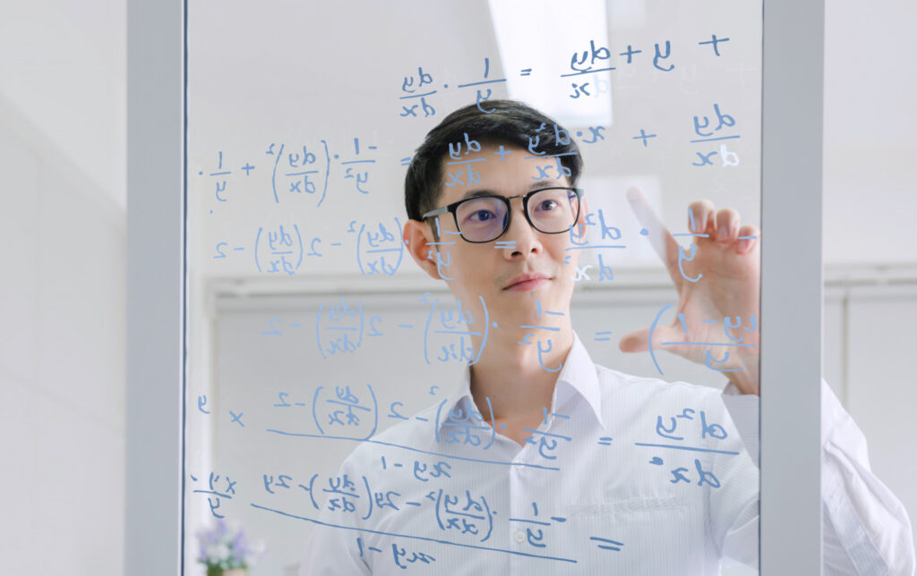 photo-of-male-mathematician-working-on-complex-formula