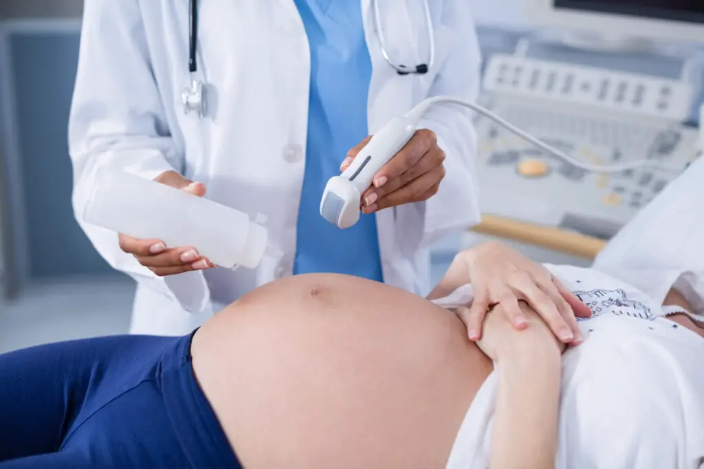 photo-of-woman-receiving-ultrasound-from-sonographer