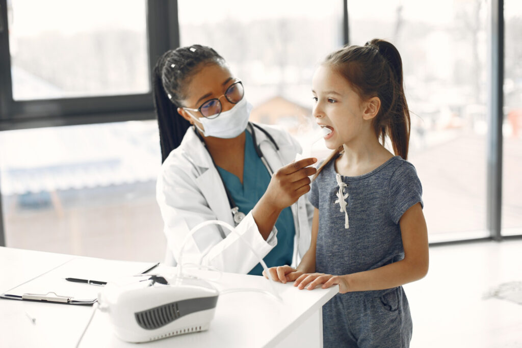 photo-of-respiratory-therapist-who-studied-at-trade-school-helping-child-breathe