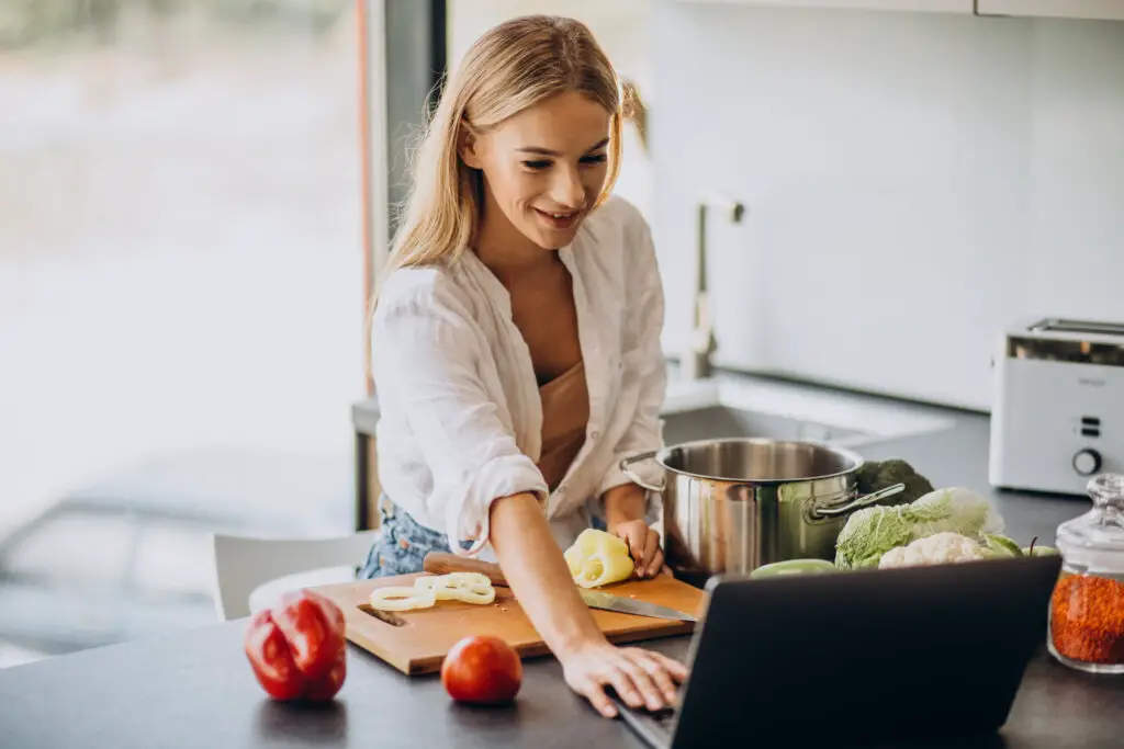 photo-of-student-using-recipe-website-on-laptop-to-cook