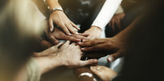 Closeup of diverse people joining their hands