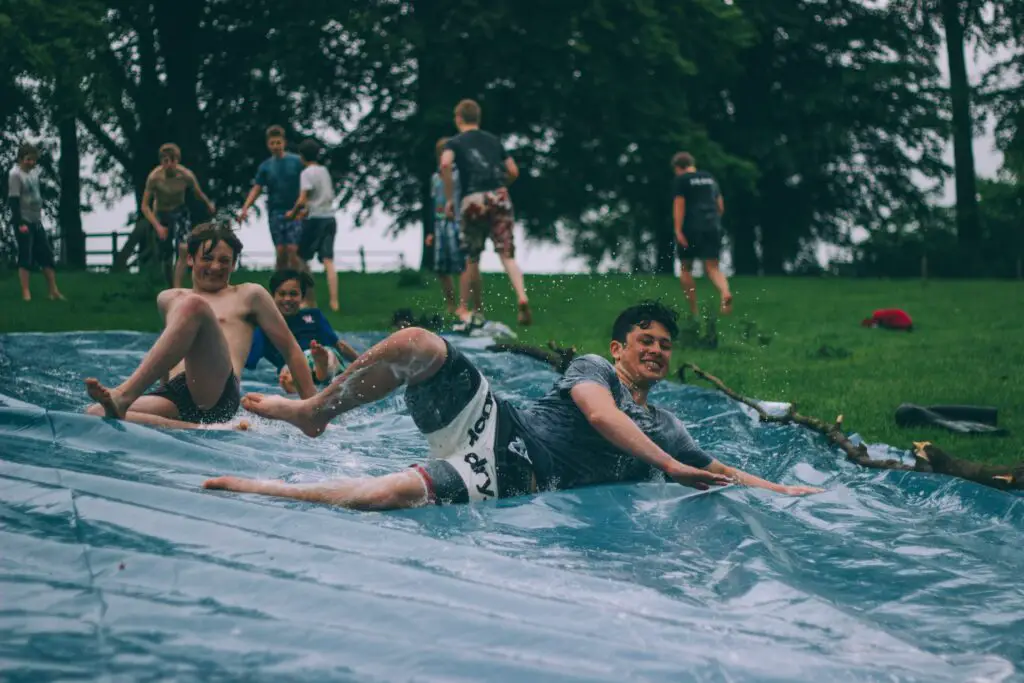 students enjoying a water slide