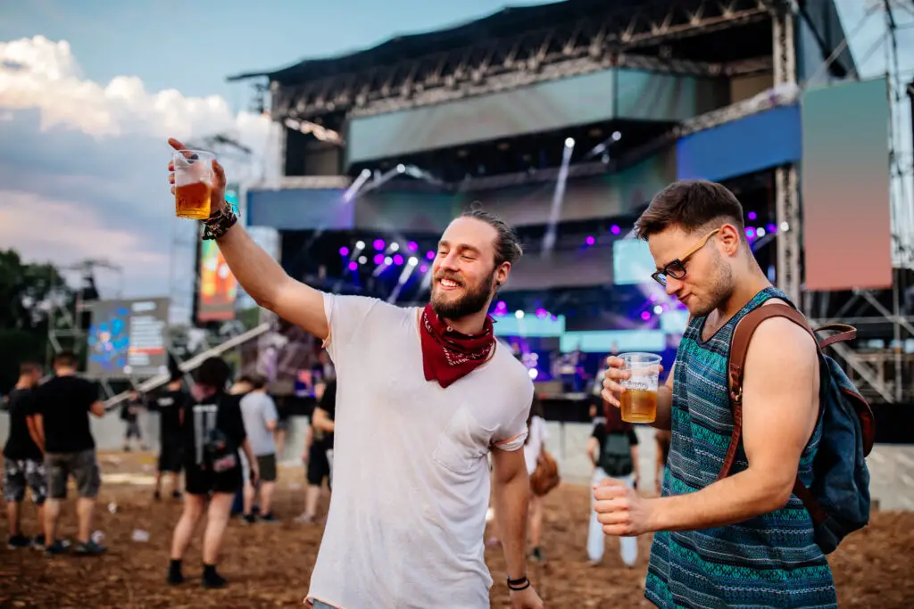 Two male friends enjoying at a music festival