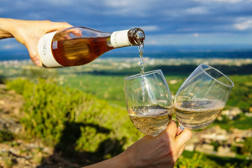 Pouring wine in glasses in a vineyard