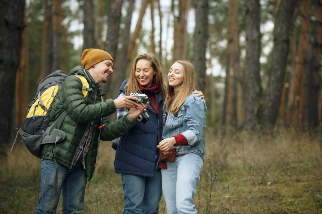 Group of friends on a camping or hiking trip in autumn day