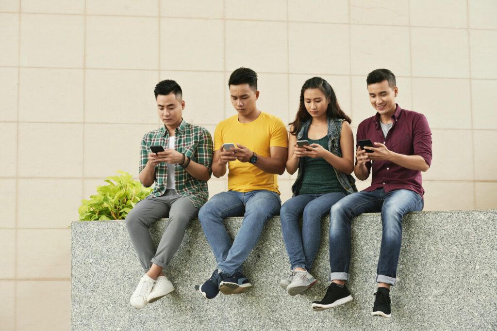 a group of students checking their social media accounts in time for college admissions