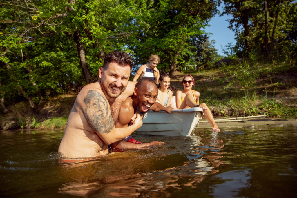 Happy group of friends in the river in a bustling college town.