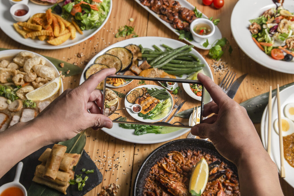 Taking photo of food on his smartphone