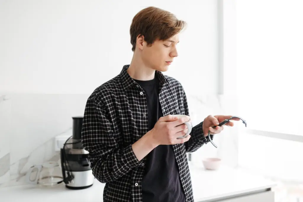 young man checking his watch to know how much time he spends on distractions 