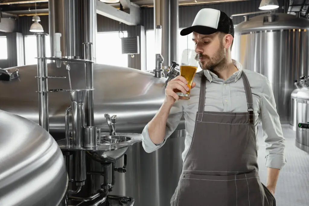 Professional brewer smelling beer