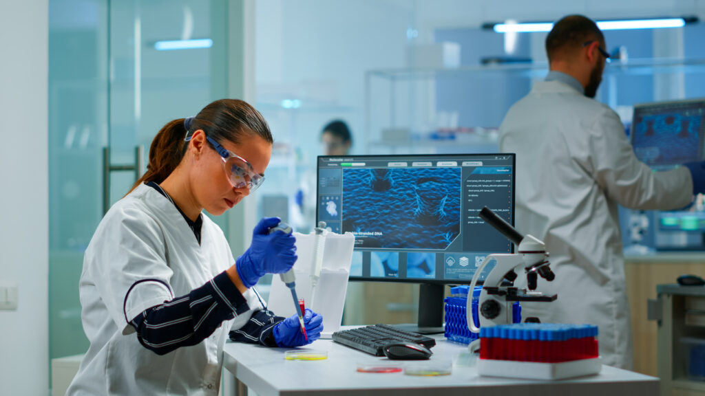 Scientist with equipment in laboratory