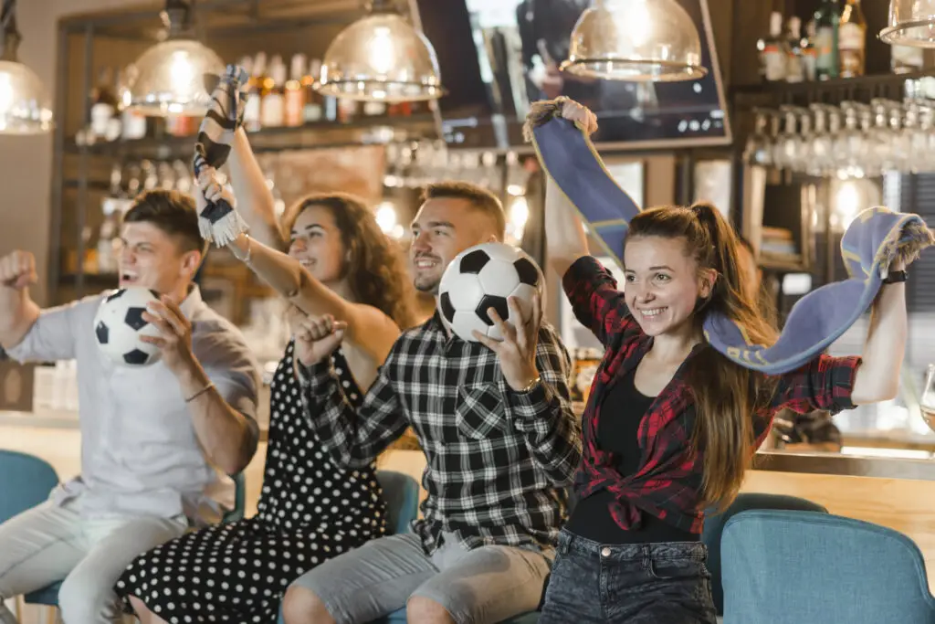 Soccer fans cheering in a bar