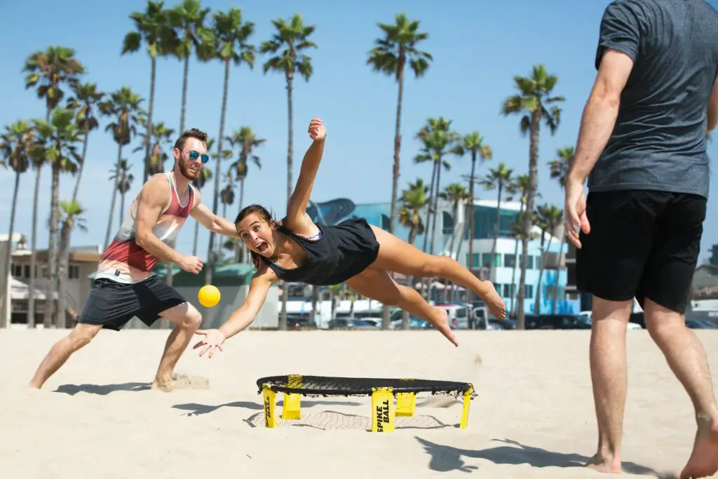 Friends play spikeball in the beach in Irvine college town