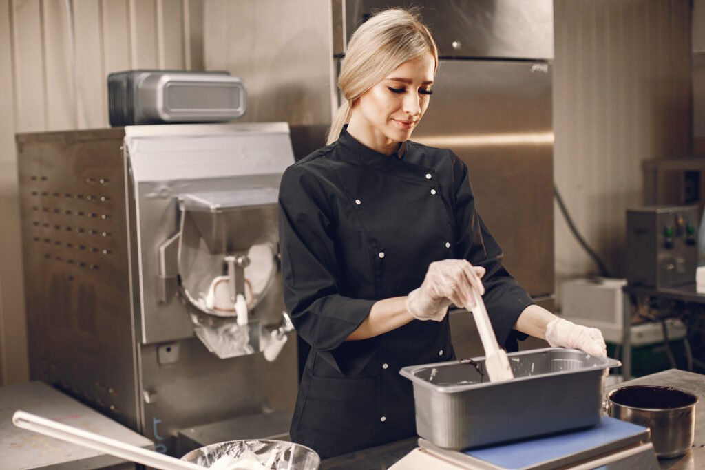 Woman making ice cream at commercial kitchen