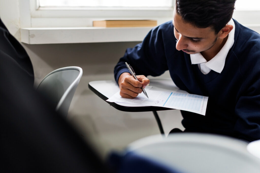 a young student taking a difficult exam