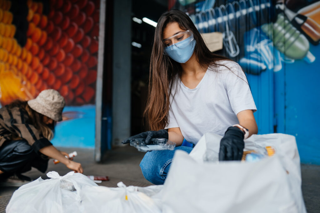 Young woman sorting garbage