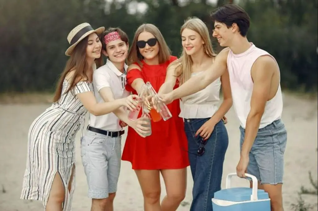 Group of friends clicking their beer bottles