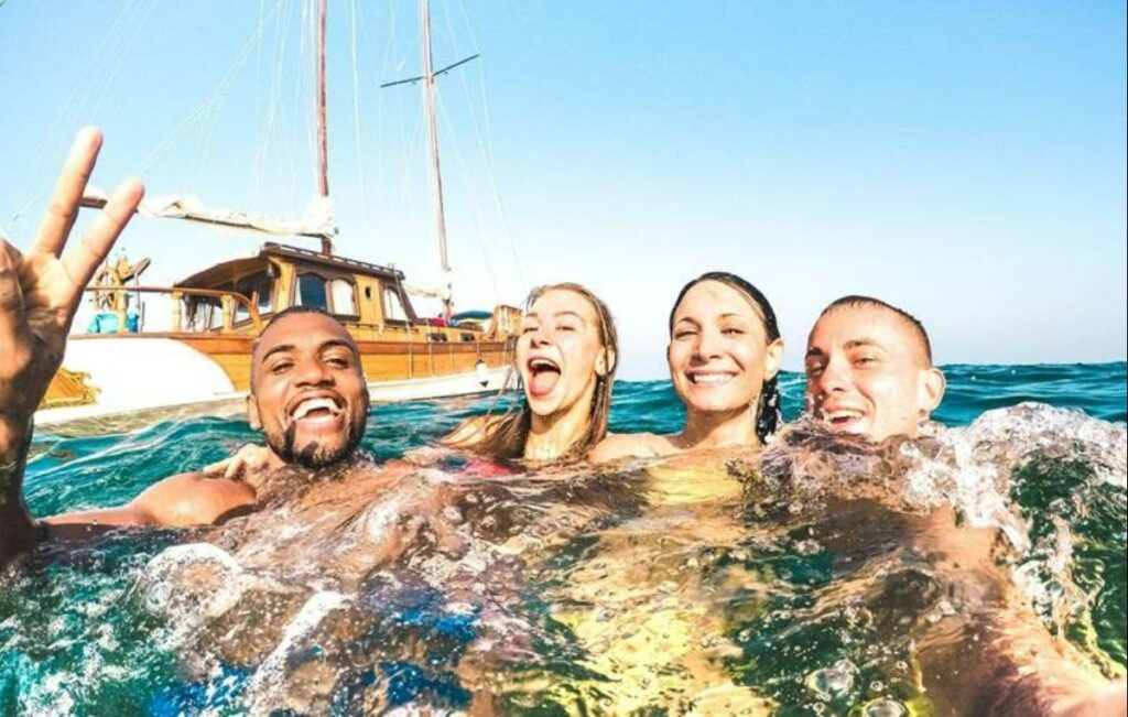 Group of friends posing for a photo in the ocean.