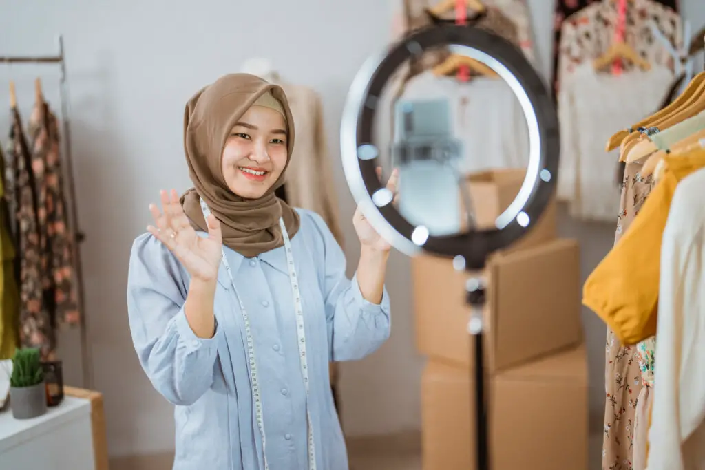 young muslim student welcomes viewers to her live online selling gig