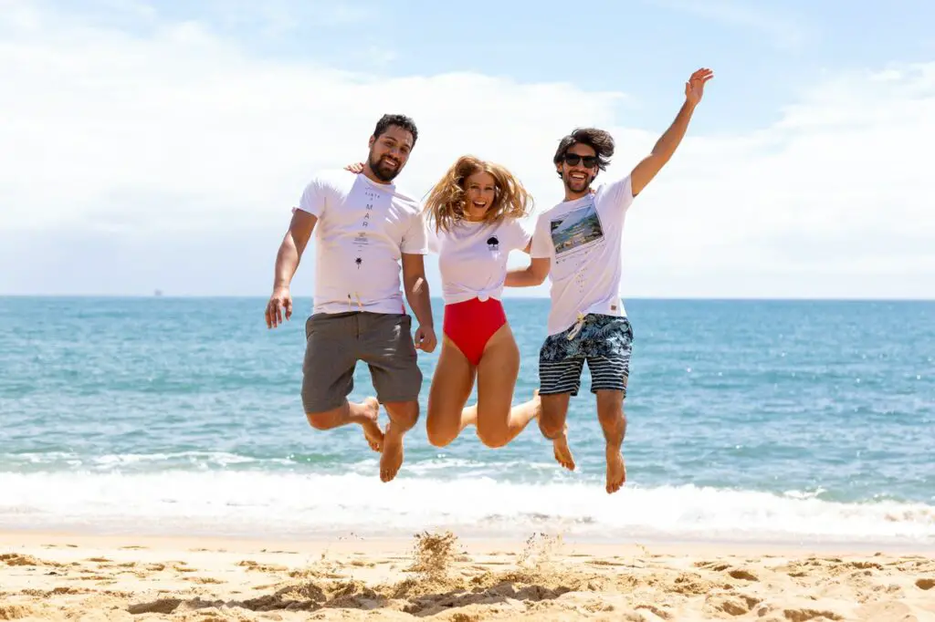 Three friends jump on the beach