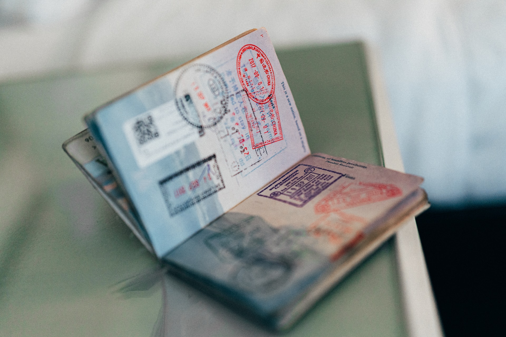 stamped passport placed on a bedside table