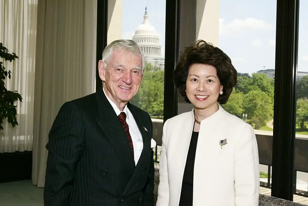 Former-us-secretary-of-transportation-elan-chao-and-dole-foods-ceo-richest-people-without-college-degree-david-murdock-smile-at-the-camera