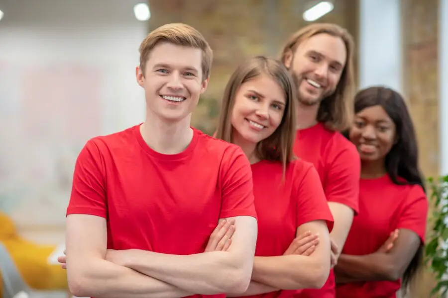 happy-college-students-in-red-tee-shirts-extracurricular-group