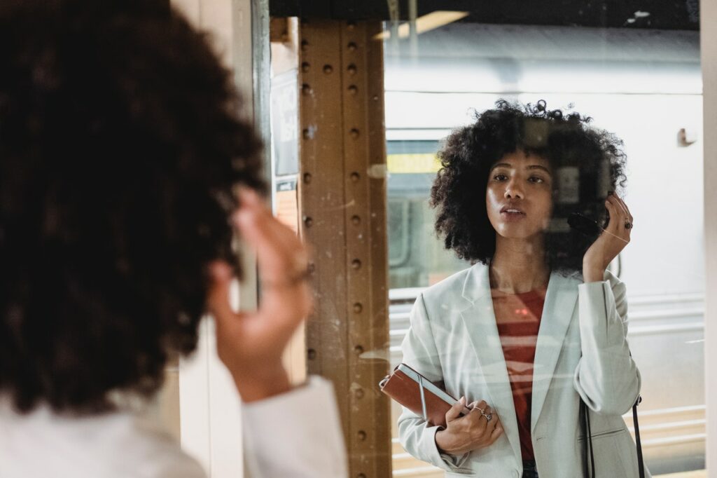 female college student motivating to herself in the mirror before the big speech