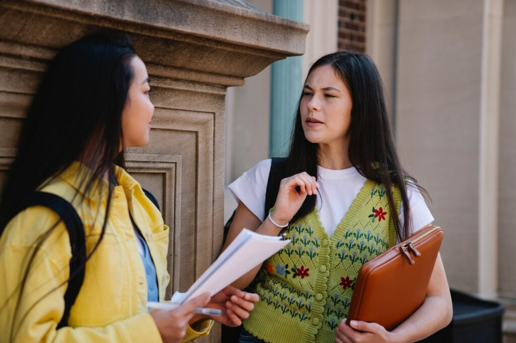 two college students discussing their preparation for upcoming class presentations