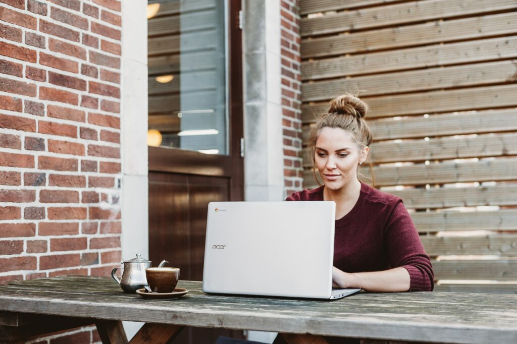 Woman working outdoors on her laptop