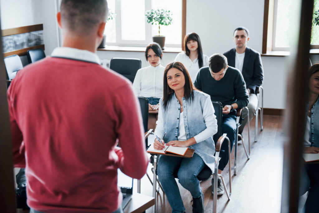 college students attentively listening to a speaker in front of the class