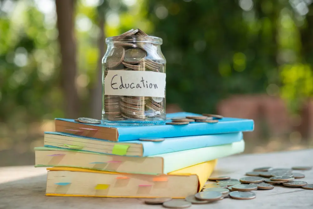 coins-in-glass-jar-placed-on-top-of-books-to-pay-for-college