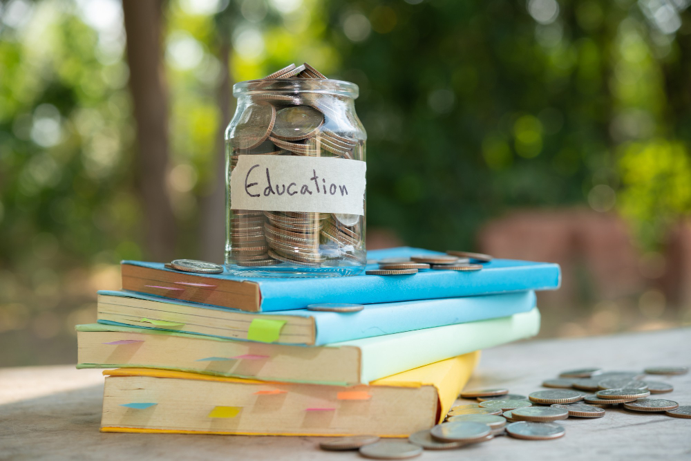 coins-in-glass-jar-placed-on-top-of-books-to-pay-for-college