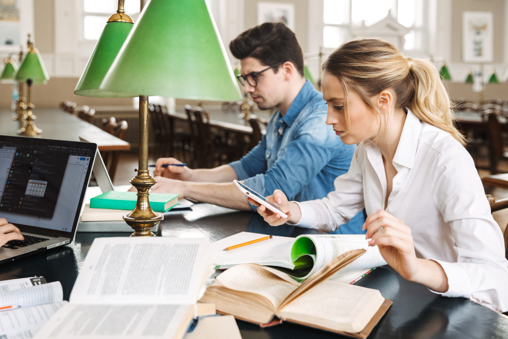 photo-of-college-students-preparing-for-presentation-with-books-and-paper