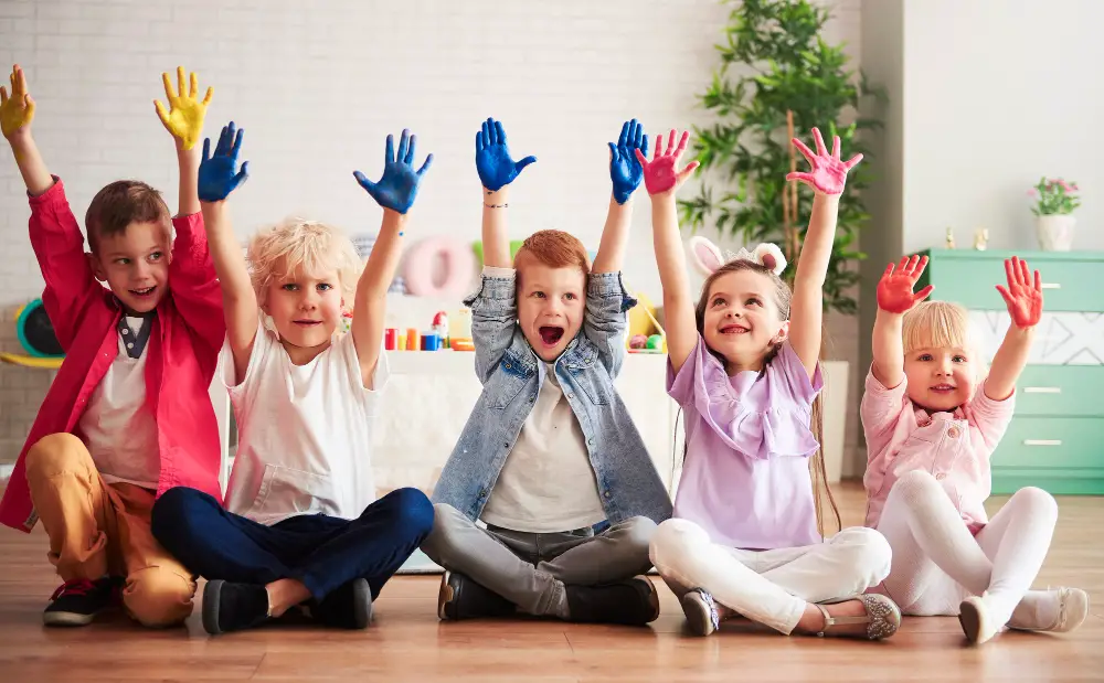 Children in a group with painted hands