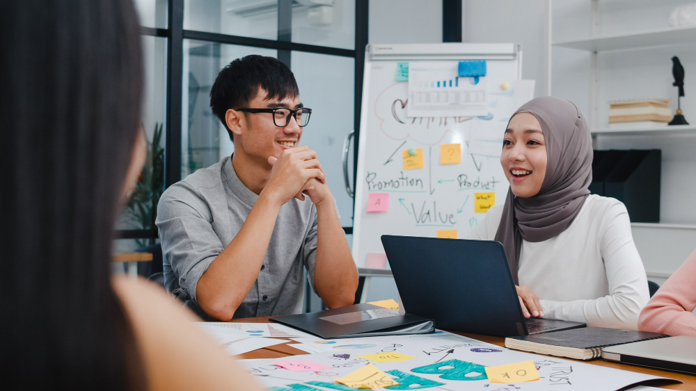 multiracial-employees-discussing-work-at-office-after-graduating