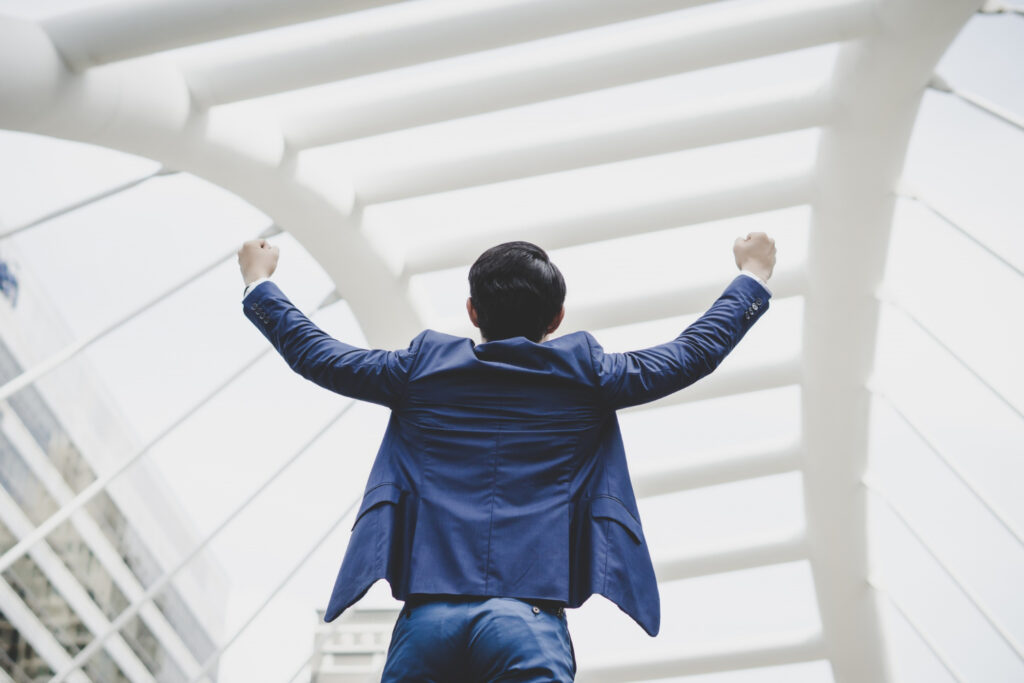 young male employee shouting for joy after securing the greatest achievement of his career