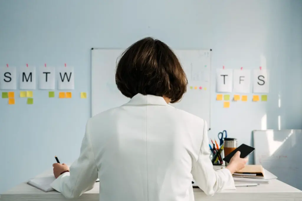 female employee looking at her schedule and to-do list to organize her daily tasks