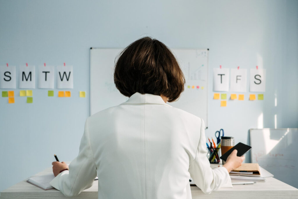 female employee looking at her schedule and to-do list to organize her daily tasks