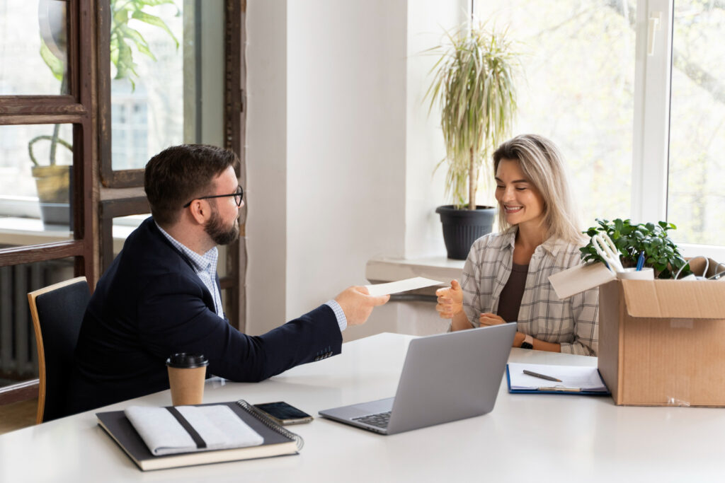 young female employee amicably splits with boss and receives last paycheck