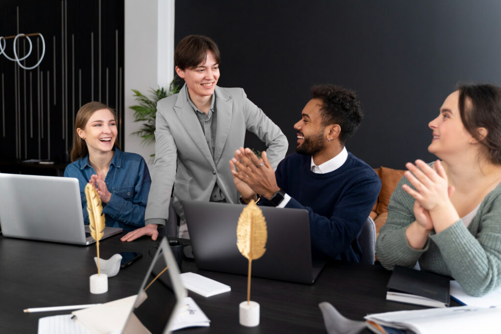 a diverse group of workers applauding their manager for resolving an issue