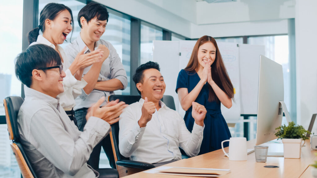 colleagues celebrating a fellow worker's win