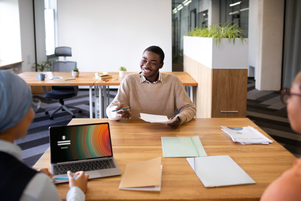 young black college graduate in job interview telling employers what interested him about the role