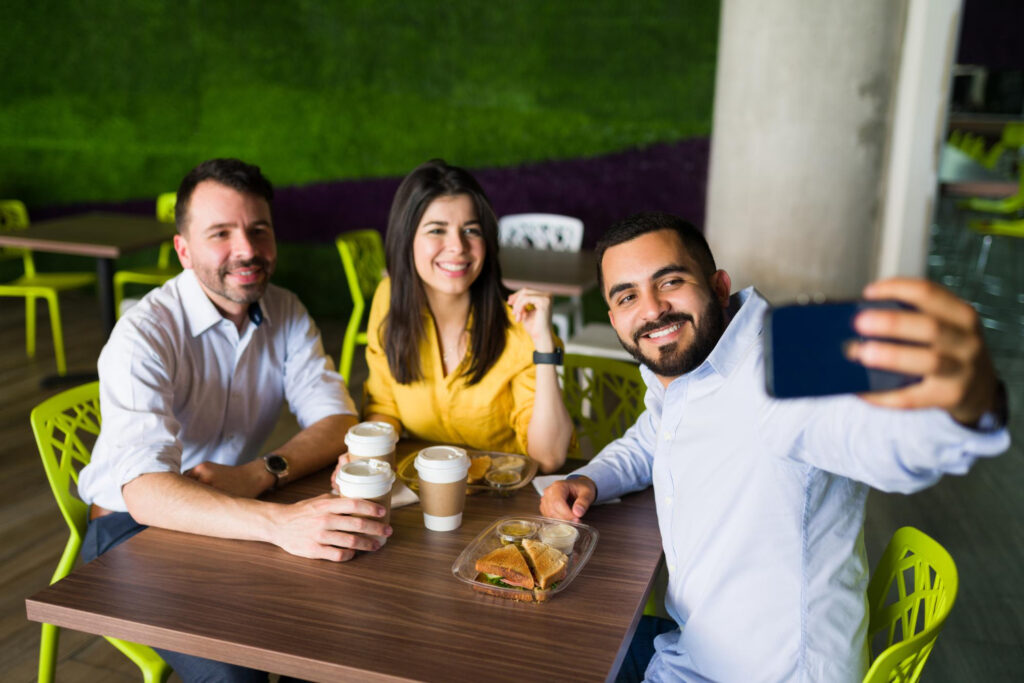 friendly co-workers taking a photo after enjoying their lunch break together