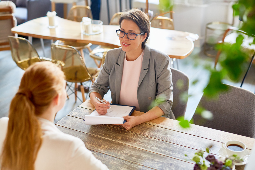 interviewer-talking-to-female-candidate-about-acceptance-to-ivy-league-college