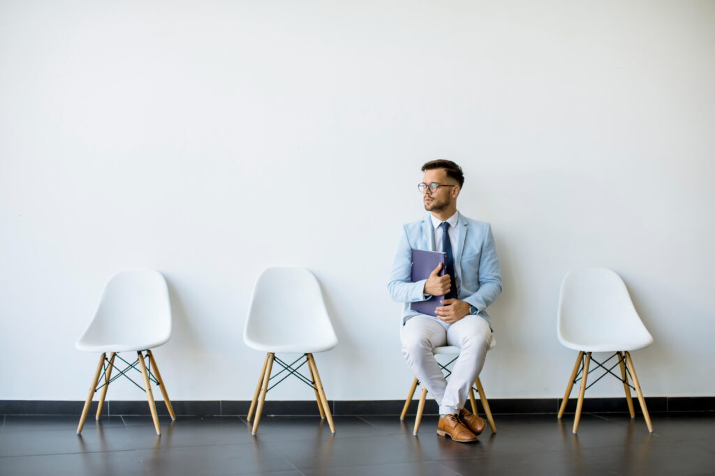 fresh graduate contemplating how to answer common interview questions while waiting for his turn