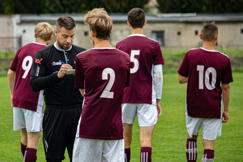 sports-referee-talking-to-player-on-the-field