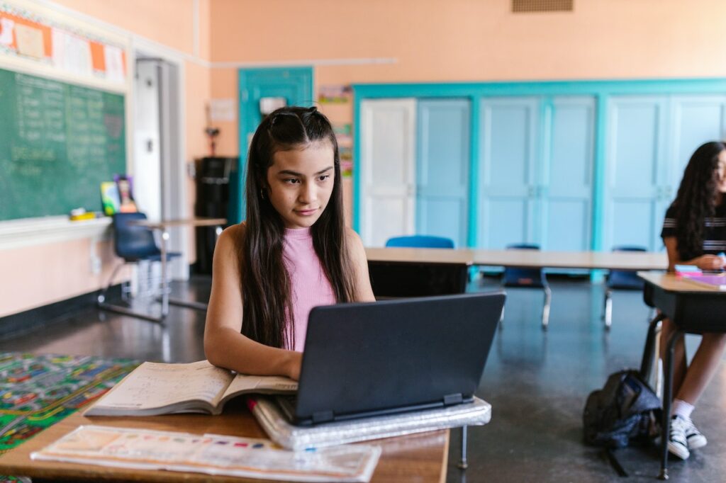 young female undocumented student in public school searching for potential colleges