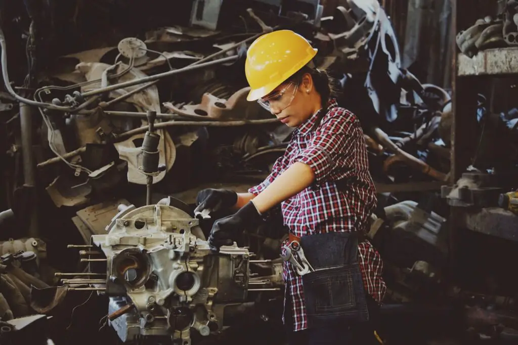female undocumented student learning how to be a mechanic in a trade school