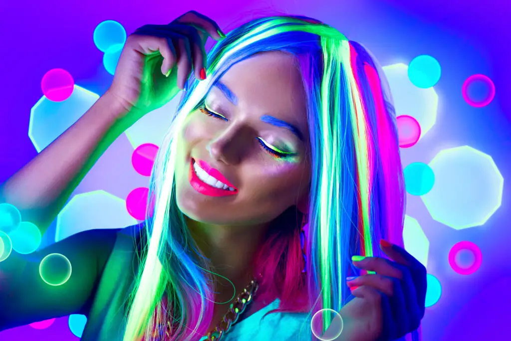 female-student-wearing-glow-in-the-dark-wig-and-makeup-have-fun-at-a-college-party